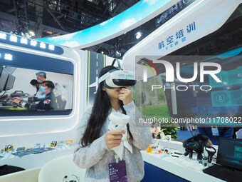 Visitors experience the ''VR Aviation Training System'' at the 2nd CATA Aviation Conference in Beijing, China, on October 26, 2024. (