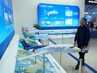 Viewers visit aircraft models at the 2nd CATA Aviation Conference in Beijing, China, on October 26, 2024. (