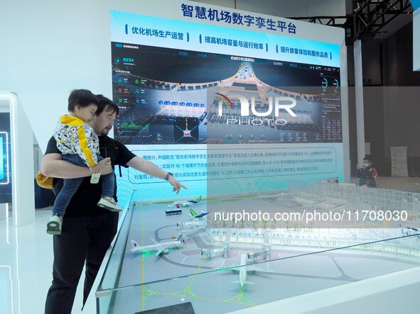 The audience visits the ''Smart Airport Digital Twin Platform Model'' at the 2nd CATA Aviation Conference in Beijing, China, on October 26,...