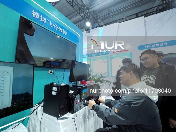 Viewers experience ''simulated flight'' at the 2nd CATA Aviation Conference in Beijing, China, on October 26, 2024. 