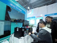 Viewers experience ''simulated flight'' at the 2nd CATA Aviation Conference in Beijing, China, on October 26, 2024. (