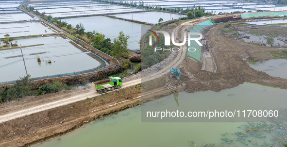 Workers work on the Hongze Lake water conservancy project in Suqian, Jiangsu province, China, on October 26, 2024. 