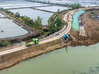 Workers work on the Hongze Lake water conservancy project in Suqian, Jiangsu province, China, on October 26, 2024. (