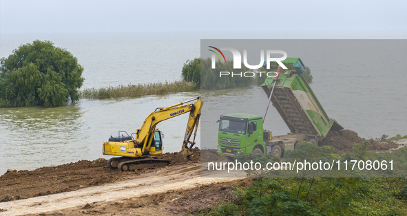 Workers work on the Hongze Lake water conservancy project in Suqian, Jiangsu province, China, on October 26, 2024. 