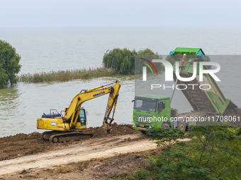 Workers work on the Hongze Lake water conservancy project in Suqian, Jiangsu province, China, on October 26, 2024. (