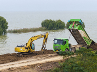 Workers work on the Hongze Lake water conservancy project in Suqian, Jiangsu province, China, on October 26, 2024. (