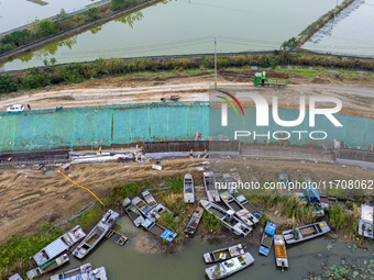 Workers work on the Hongze Lake water conservancy project in Suqian, Jiangsu province, China, on October 26, 2024. (