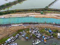 Workers work on the Hongze Lake water conservancy project in Suqian, Jiangsu province, China, on October 26, 2024. (