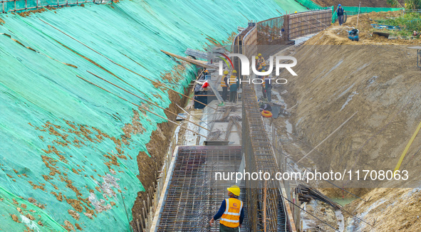 Workers work on the Hongze Lake water conservancy project in Suqian, Jiangsu province, China, on October 26, 2024. 