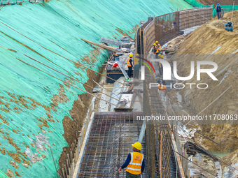 Workers work on the Hongze Lake water conservancy project in Suqian, Jiangsu province, China, on October 26, 2024. (