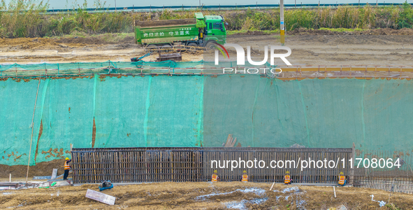 Workers work on the Hongze Lake water conservancy project in Suqian, Jiangsu province, China, on October 26, 2024. 