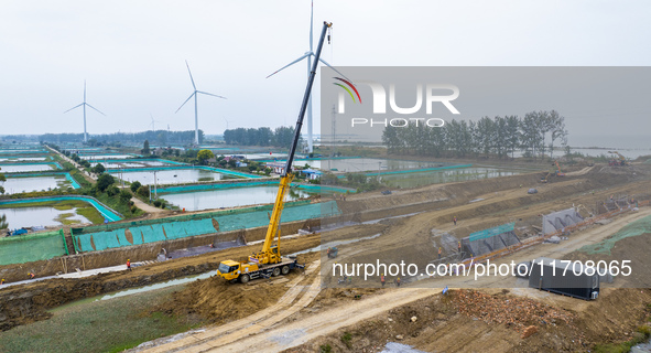 Workers work on the Hongze Lake water conservancy project in Suqian, Jiangsu province, China, on October 26, 2024. 