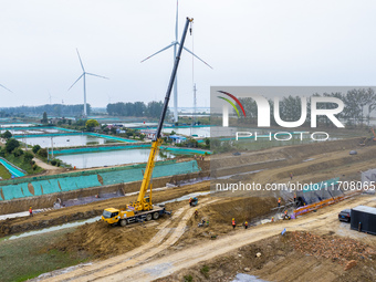 Workers work on the Hongze Lake water conservancy project in Suqian, Jiangsu province, China, on October 26, 2024. (