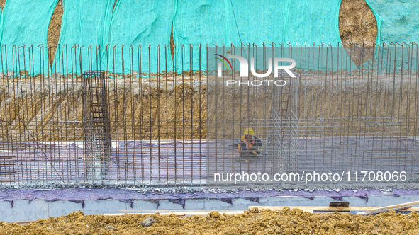 Workers work on the Hongze Lake water conservancy project in Suqian, Jiangsu province, China, on October 26, 2024. 