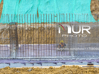 Workers work on the Hongze Lake water conservancy project in Suqian, Jiangsu province, China, on October 26, 2024. (