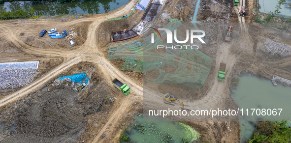 Workers work on the Hongze Lake water conservancy project in Suqian, Jiangsu province, China, on October 26, 2024. 