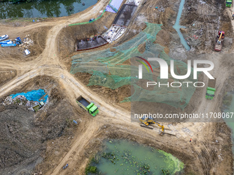 Workers work on the Hongze Lake water conservancy project in Suqian, Jiangsu province, China, on October 26, 2024. (