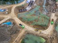 Workers work on the Hongze Lake water conservancy project in Suqian, Jiangsu province, China, on October 26, 2024. (