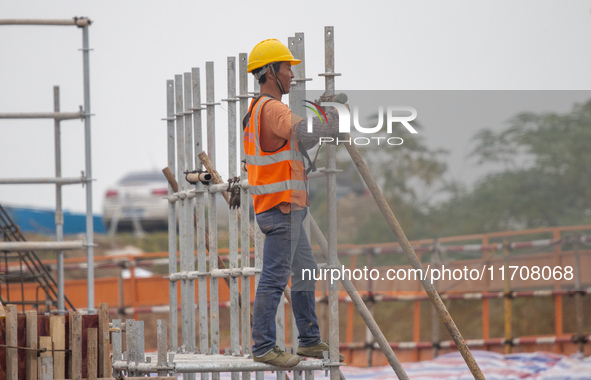 Workers work on the Hongze Lake water conservancy project in Suqian, Jiangsu province, China, on October 26, 2024. 