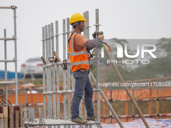 Workers work on the Hongze Lake water conservancy project in Suqian, Jiangsu province, China, on October 26, 2024. (