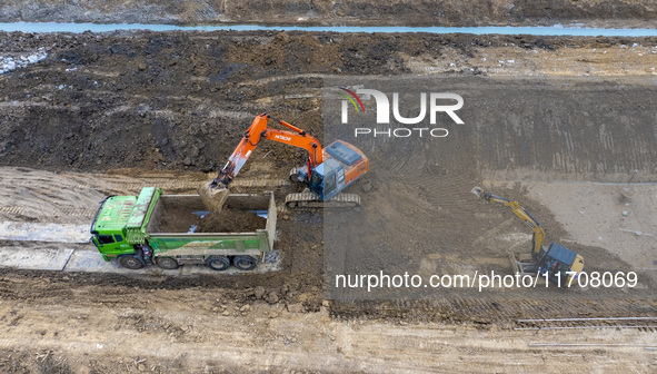 Workers work on the Hongze Lake water conservancy project in Suqian, Jiangsu province, China, on October 26, 2024. 