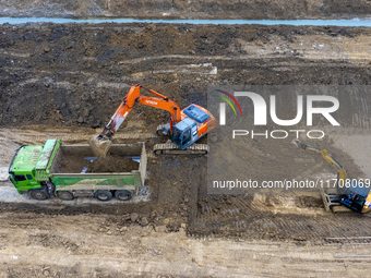 Workers work on the Hongze Lake water conservancy project in Suqian, Jiangsu province, China, on October 26, 2024. (