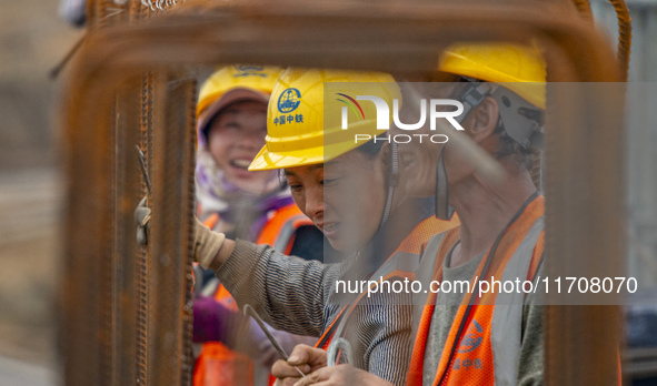 Workers work on the Hongze Lake water conservancy project in Suqian, Jiangsu province, China, on October 26, 2024. 