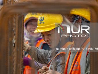 Workers work on the Hongze Lake water conservancy project in Suqian, Jiangsu province, China, on October 26, 2024. (