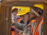 Workers work on the Hongze Lake water conservancy project in Suqian, Jiangsu province, China, on October 26, 2024. (