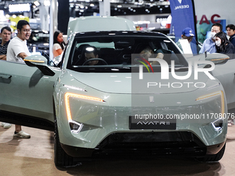 Visitors inspect a DEEPAL AVATR 11 electric car at the Bangkok EV Expo 2024 in Bangkok, Thailand, on October 26, 2024. The Bangkok EV Expo 2...