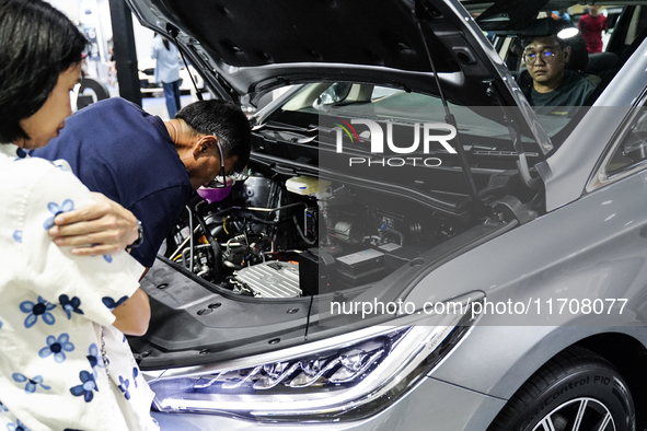 Visitors inspect a BYD M6 electric car at the Bangkok EV Expo 2024 in Bangkok, Thailand, on October 26, 2024. The Bangkok EV Expo 2024 is an...