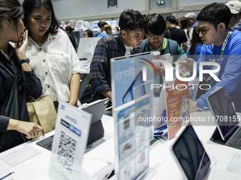 Visitors inspect the Apple iPad Air at the Thailand Mobile Expo 2024 in Bangkok, Thailand, on October 26, 2024. The expo showcases the newes...