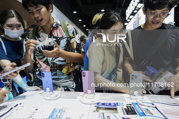 Visitors inspect the Apple iPhone 16 at the Thailand Mobile Expo 2024 in Bangkok, Thailand, on October 26, 2024. The expo showcases the newe...