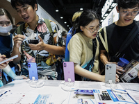 Visitors inspect the Apple iPhone 16 at the Thailand Mobile Expo 2024 in Bangkok, Thailand, on October 26, 2024. The expo showcases the newe...