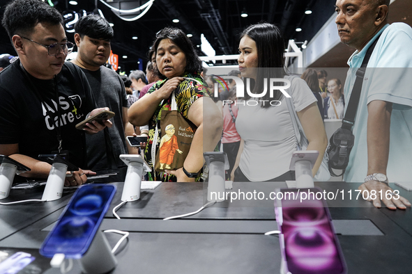 Visitors inspect the Apple iPhone 16 at the Thailand Mobile Expo 2024 in Bangkok, Thailand, on October 26, 2024. The expo showcases the newe...