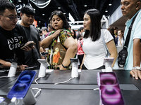 Visitors inspect the Apple iPhone 16 at the Thailand Mobile Expo 2024 in Bangkok, Thailand, on October 26, 2024. The expo showcases the newe...