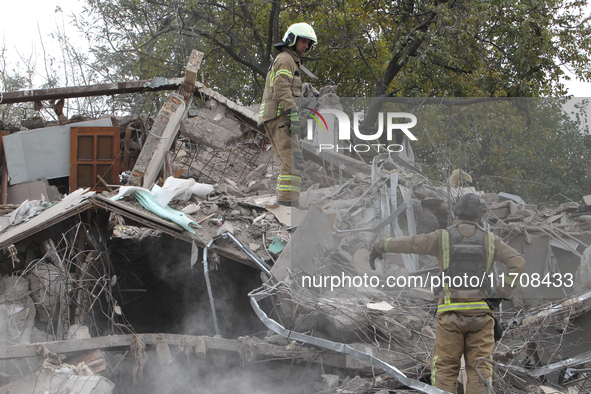 Rescuers work at the scene of an overnight Russian attack in the Novokadatskyi district of Dnipro, Ukraine, on October 25, 2024. NO USE RUSS...