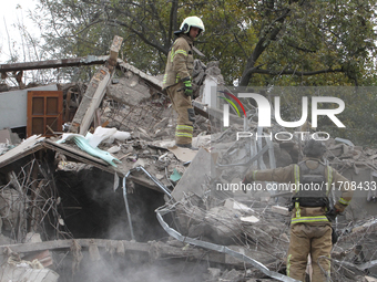 Rescuers work at the scene of an overnight Russian attack in the Novokadatskyi district of Dnipro, Ukraine, on October 25, 2024. NO USE RUSS...