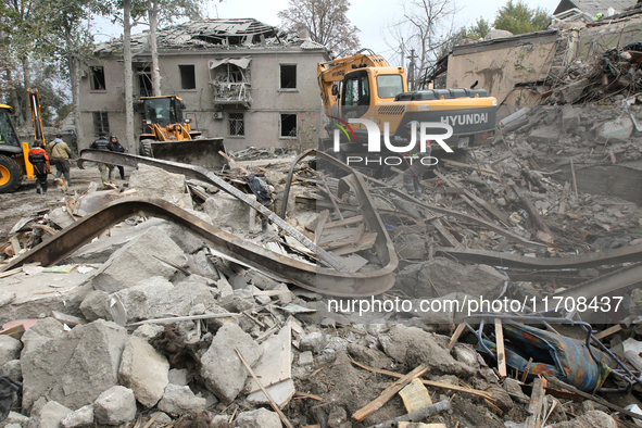 Rescuers work at the scene of an overnight Russian attack in the Novokadatskyi district of Dnipro, Ukraine, on October 25, 2024. NO USE RUSS...