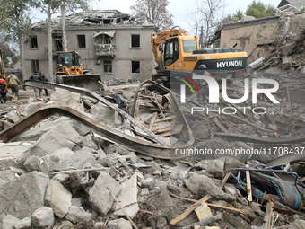 Rescuers work at the scene of an overnight Russian attack in the Novokadatskyi district of Dnipro, Ukraine, on October 25, 2024. NO USE RUSS...