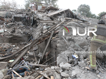 Rescuers work at the scene of an overnight Russian attack in the Novokadatskyi district of Dnipro, Ukraine, on October 25, 2024. NO USE RUSS...