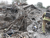 Rescuers work at the scene of an overnight Russian attack in the Novokadatskyi district of Dnipro, Ukraine, on October 25, 2024. NO USE RUSS...