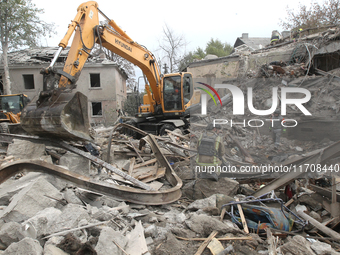 Rescuers work at the scene of an overnight Russian attack in the Novokadatskyi district of Dnipro, Ukraine, on October 25, 2024. NO USE RUSS...