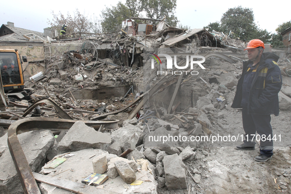 Rescuers work at the scene of an overnight Russian attack in the Novokadatskyi district of Dnipro, Ukraine, on October 25, 2024. NO USE RUSS...