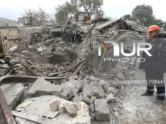 Rescuers work at the scene of an overnight Russian attack in the Novokadatskyi district of Dnipro, Ukraine, on October 25, 2024. NO USE RUSS...