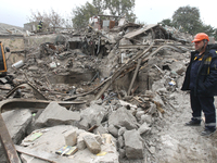 Rescuers work at the scene of an overnight Russian attack in the Novokadatskyi district of Dnipro, Ukraine, on October 25, 2024. NO USE RUSS...