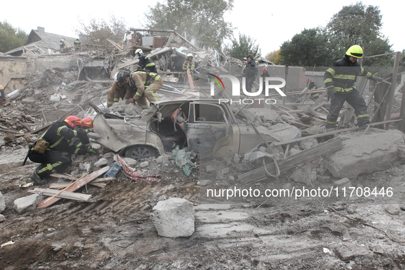 Rescuers work at the scene of an overnight Russian attack in the Novokadatskyi district of Dnipro, Ukraine, on October 25, 2024. NO USE RUSS...