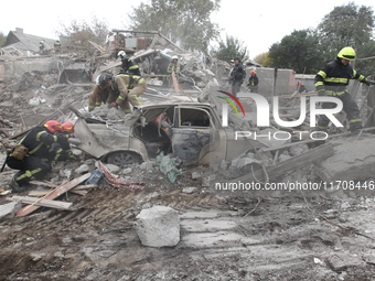 Rescuers work at the scene of an overnight Russian attack in the Novokadatskyi district of Dnipro, Ukraine, on October 25, 2024. NO USE RUSS...