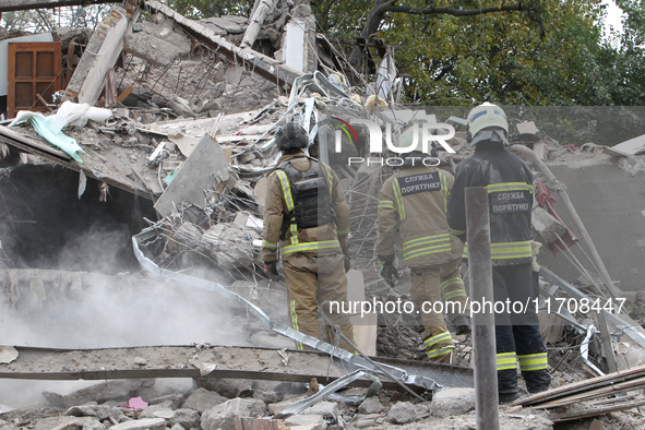 Rescuers work at the scene of an overnight Russian attack in the Novokadatskyi district of Dnipro, Ukraine, on October 25, 2024. NO USE RUSS...