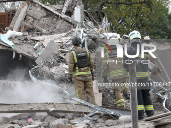 Rescuers work at the scene of an overnight Russian attack in the Novokadatskyi district of Dnipro, Ukraine, on October 25, 2024. NO USE RUSS...